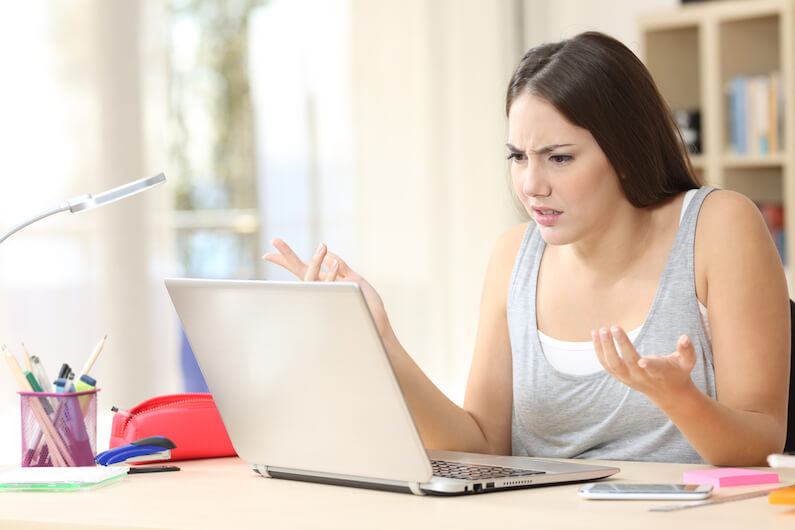 Woman looking at her computer asking why is nobody visiting website