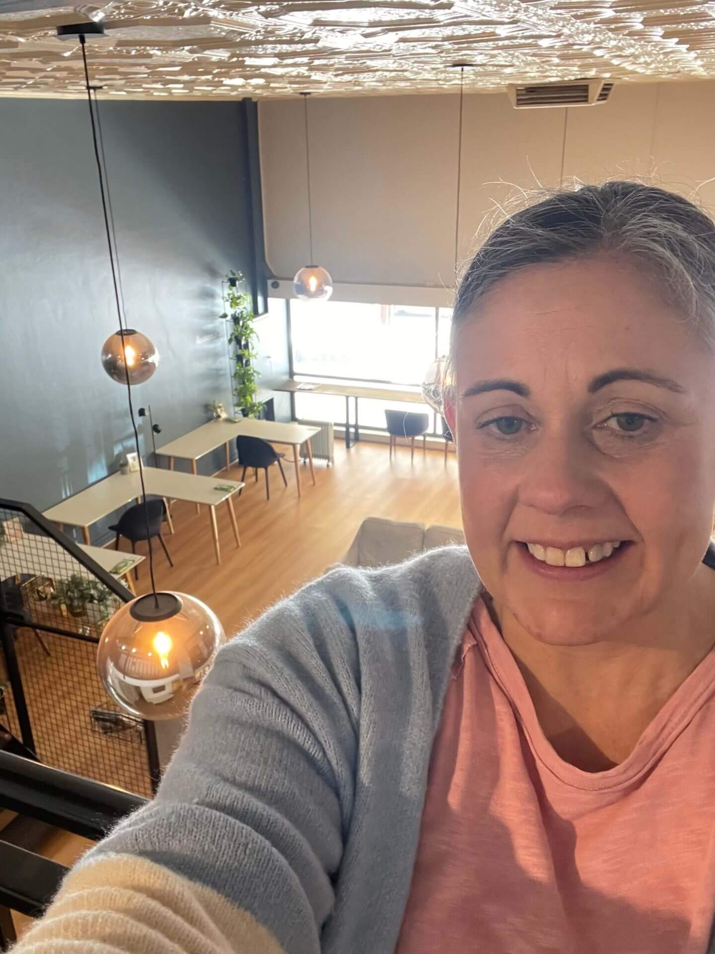 Angela is taking a selfie at the coworking space